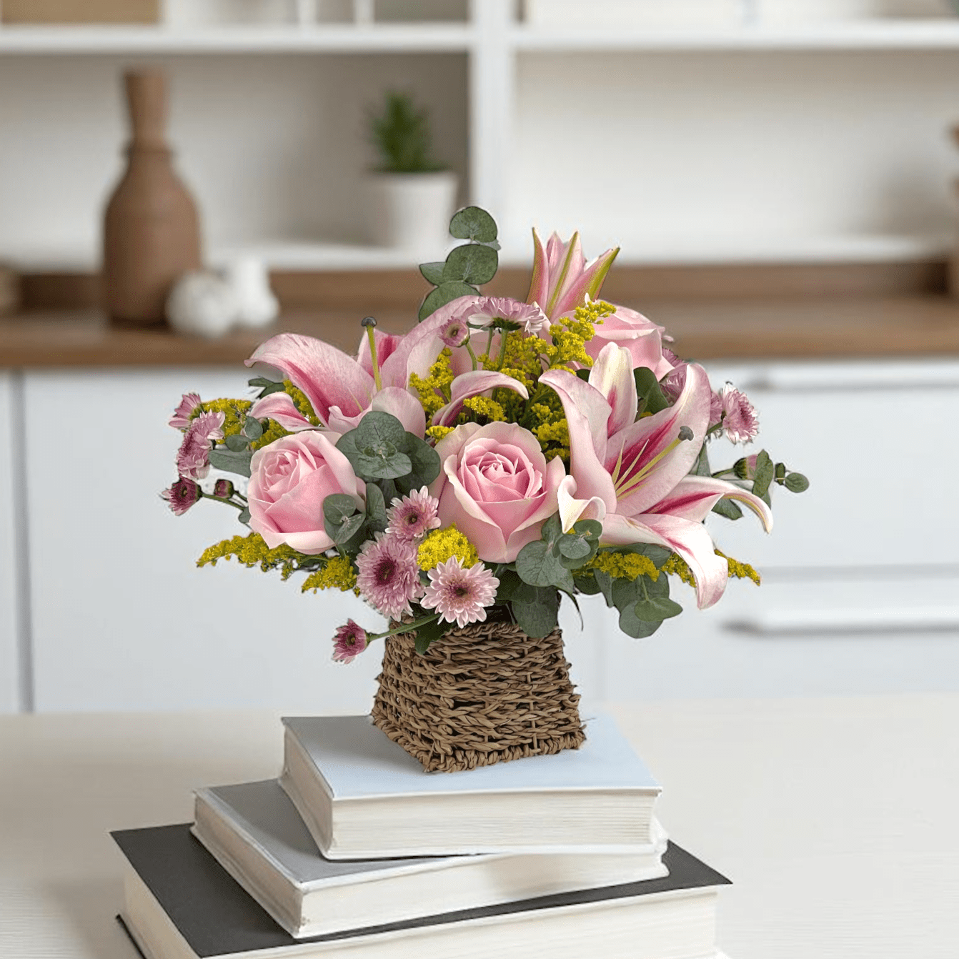Close-up of Lily Luxe basket featuring pink lilies and roses, a premium fresh flower gift with elegant design.