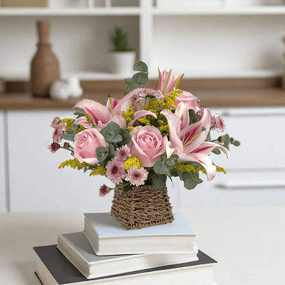 Close-up of Lily Luxe basket featuring pink lilies and roses, a premium fresh flower gift with elegant design.